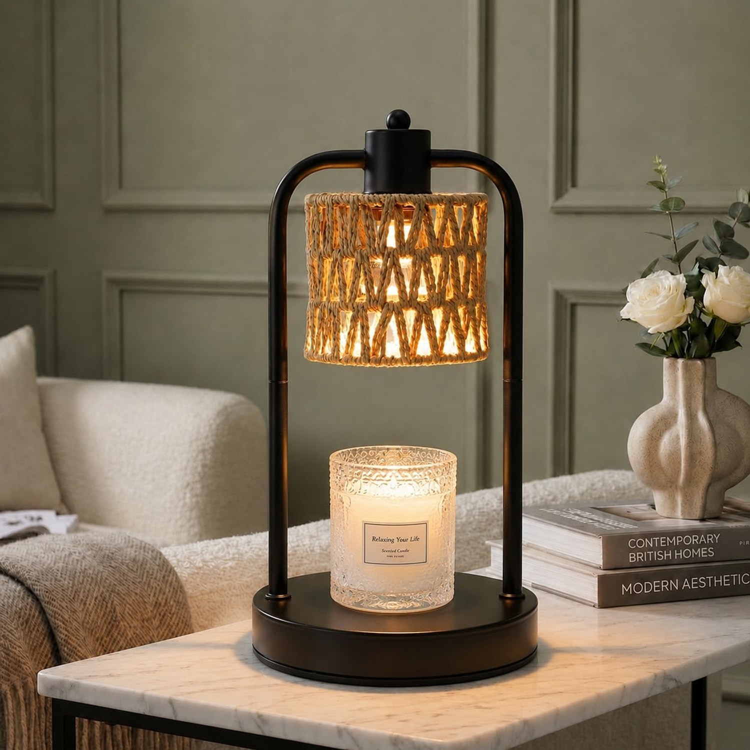 Handwoven hemp rope candle warmer lamp lit above a jar candle on a side table beside a sofa